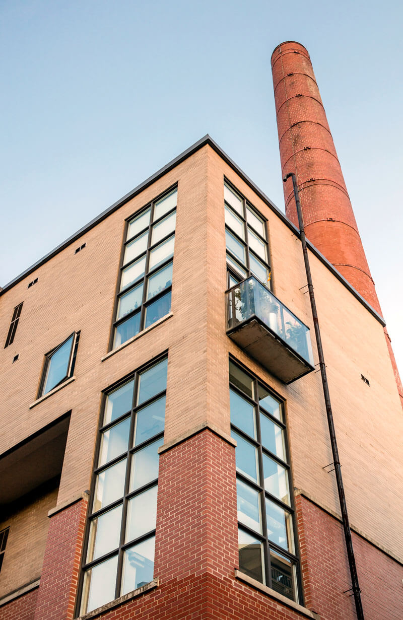 Steam Plant Lofts Showing Exterior Close Up with Smoke Stack